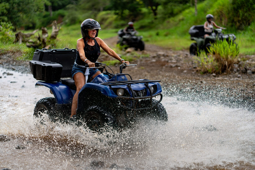 ATV crossing a river with a splash