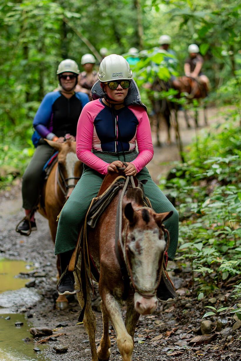 Guests horseback riding through the jungle at Vista Los Sueños Adventure Park